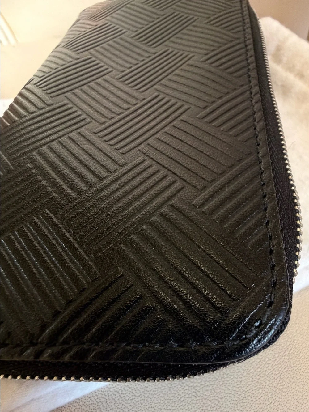 BOTTEGA VENETA Black Zip Around Wallet in Intrecciato Debossed Calfskin. UNISEX.